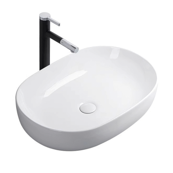 The ceramic washbasin on the bathroom countertop is oval-shaped