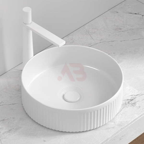 Round ceramic sink on a countertop with external line design